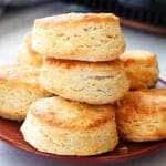 Biscuits on a plate next to air fryer.