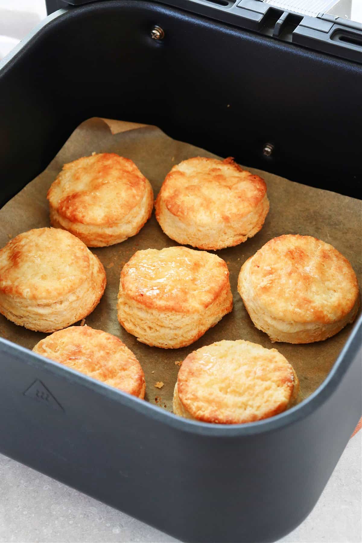 Baked biscuits in the air fryer basket.