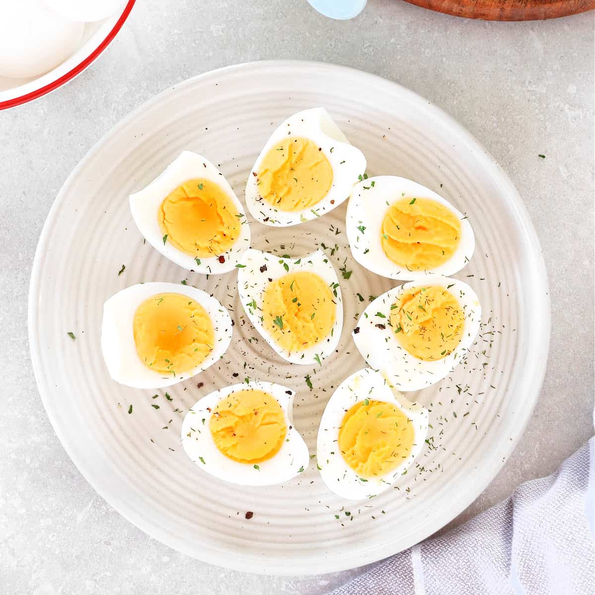 Sliced cooked eggs on a plate.