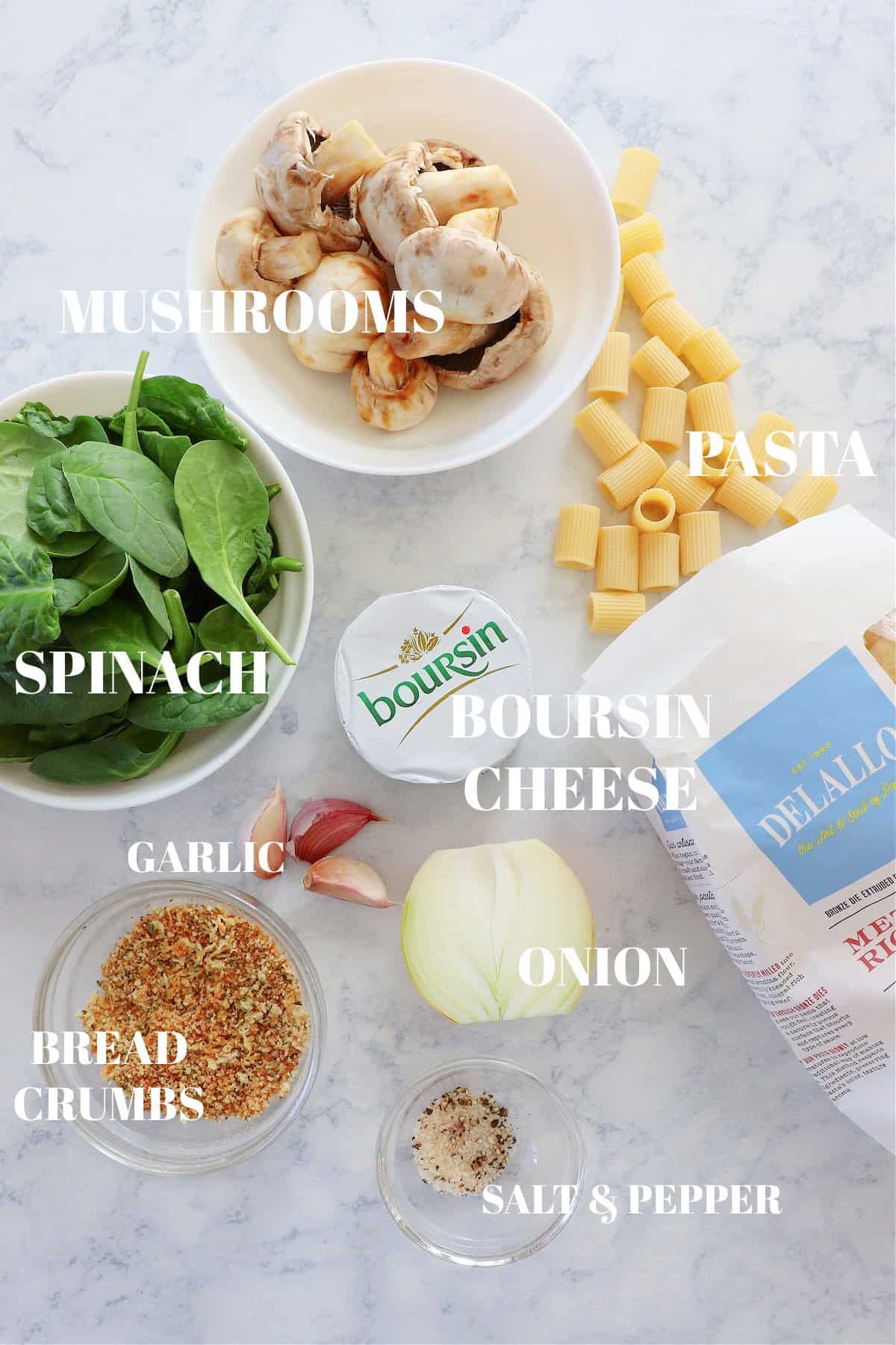 Ingredients for pasta with Boursin cheese on a marble board.