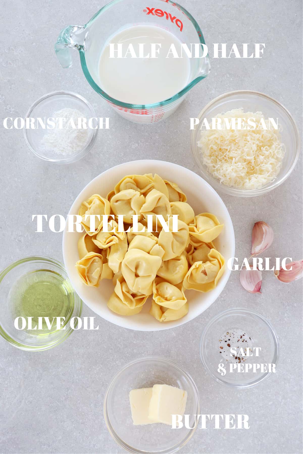 Ingredients for tortellini alfredo on a board.