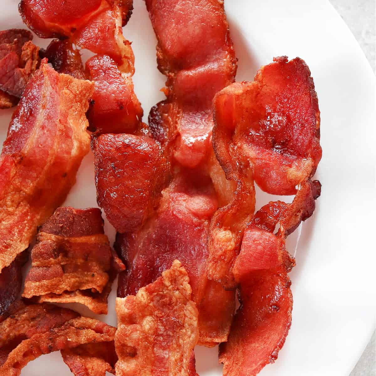 Crispy bacon on white plate.