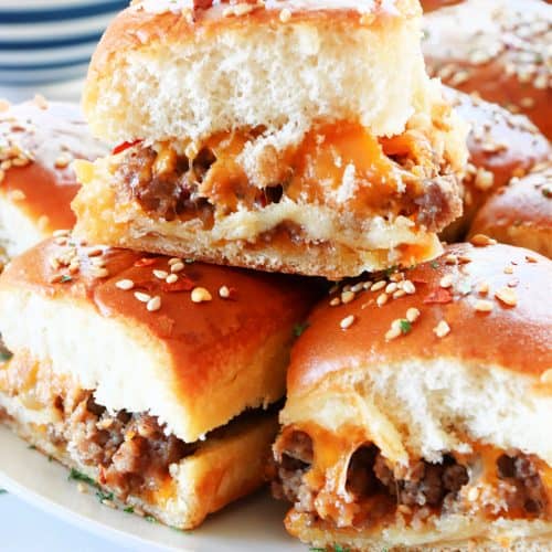 Cheeseburger sliders on a white plate.