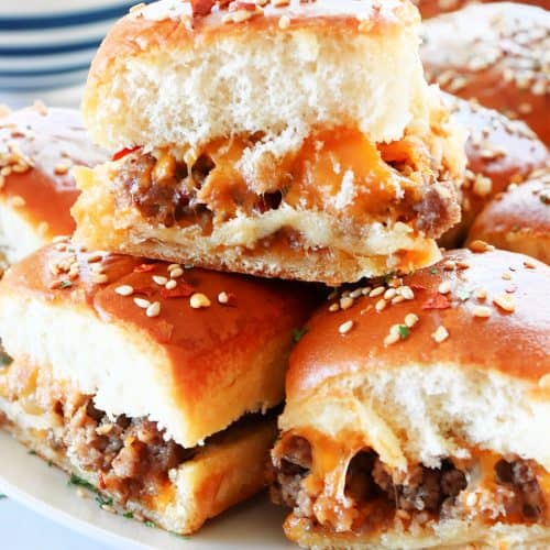 Sliders stacked on a plate.