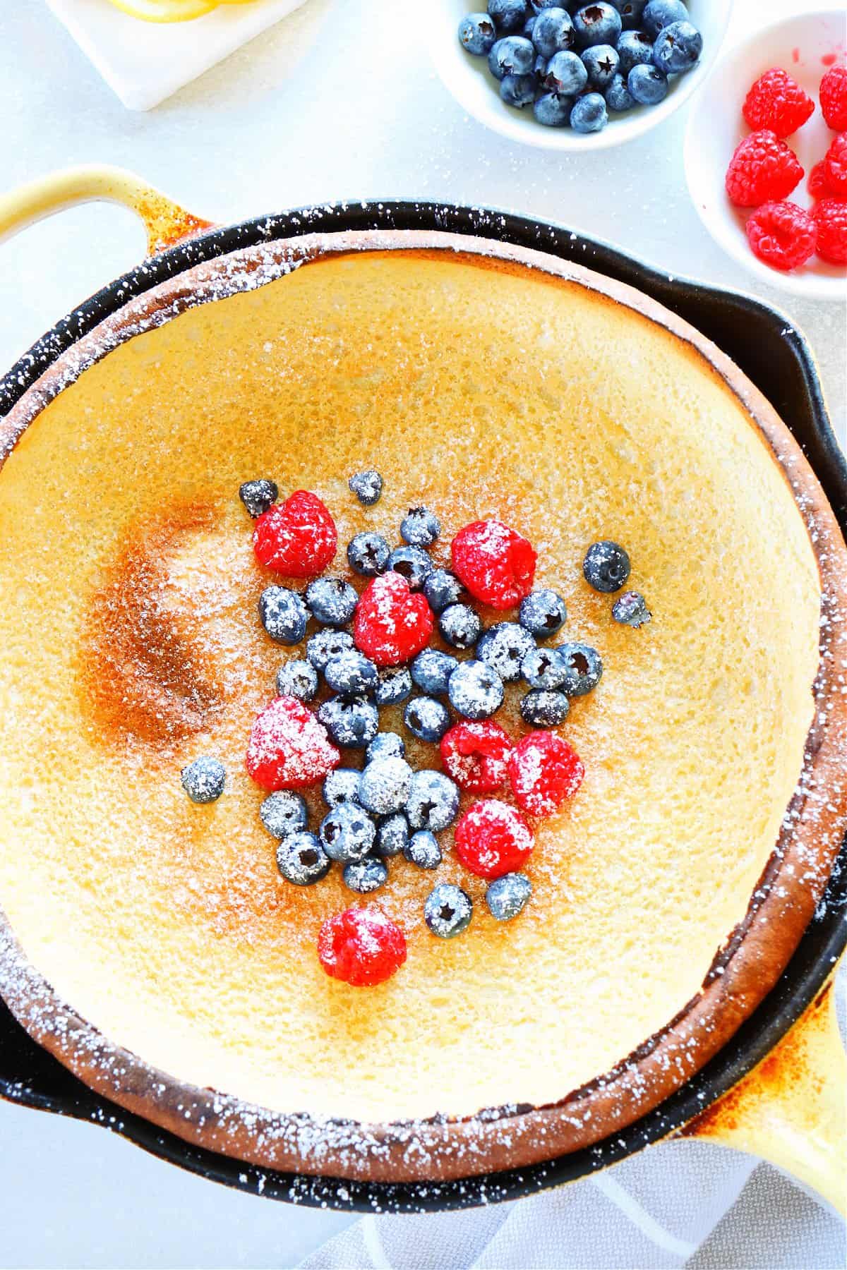 Dutch baby pancake with blueberries and raspberries.