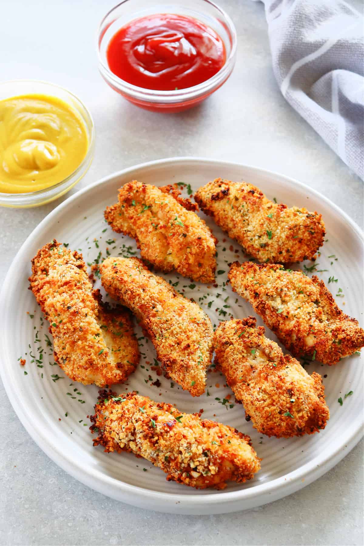 Cooked chicken tenders on a plate.