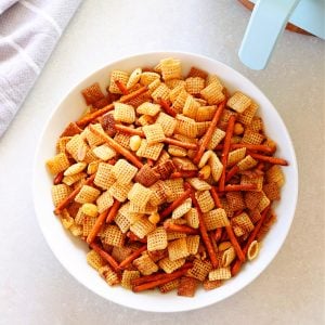 Party mix and air fryer on a board.