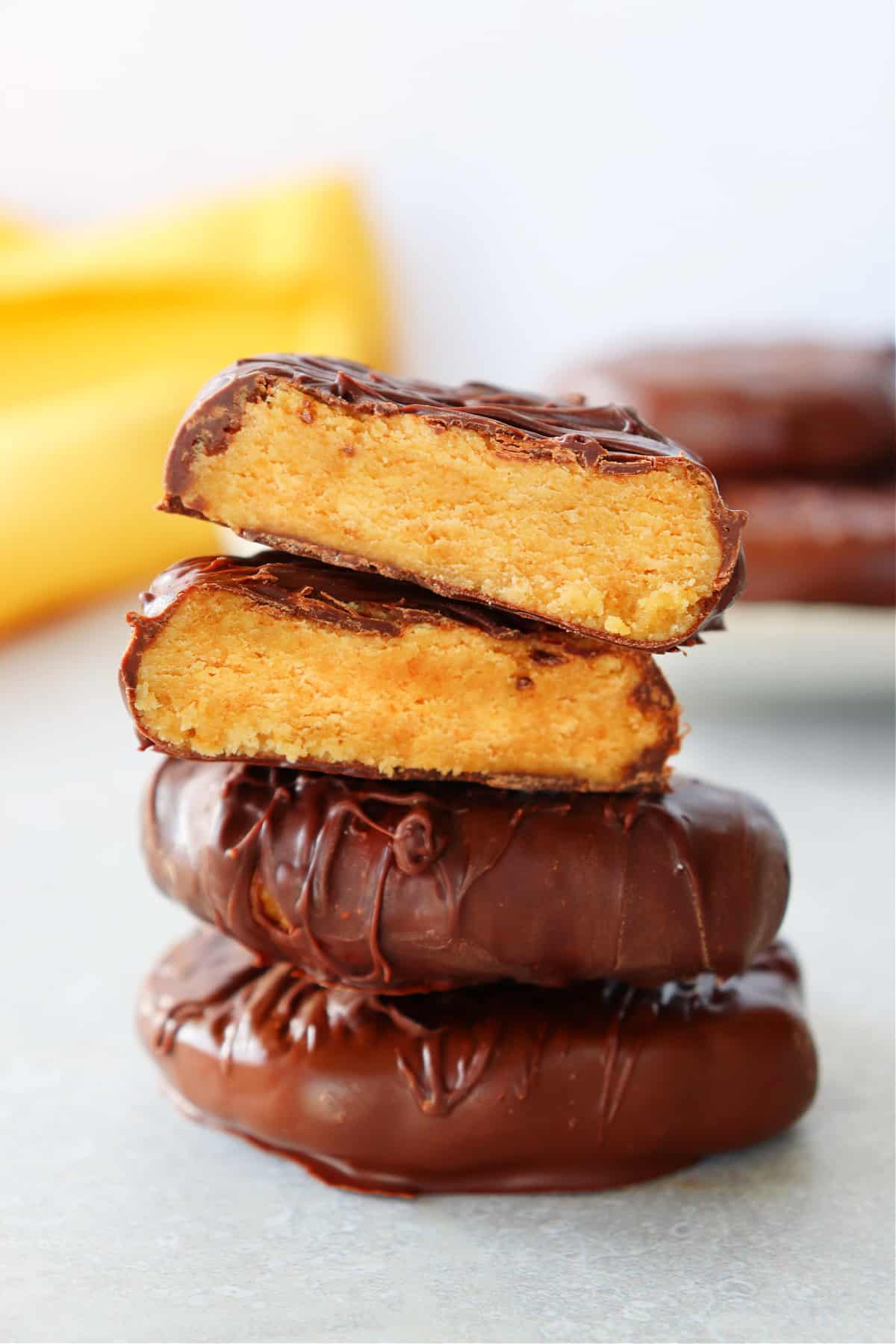 Peanut butter eggs stacked on a board.