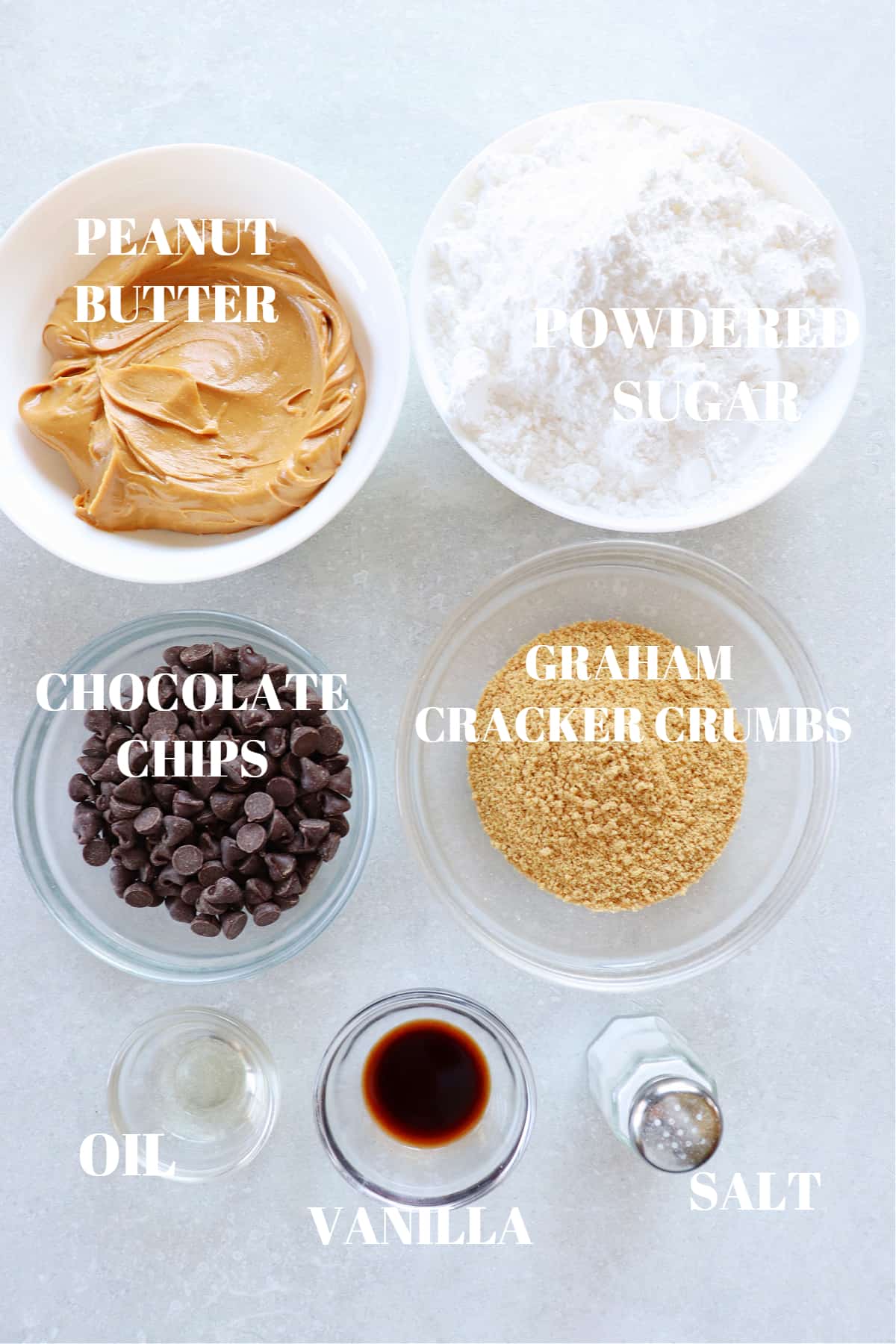 Ingredients for peanut butter eggs in small bowls on a board.
