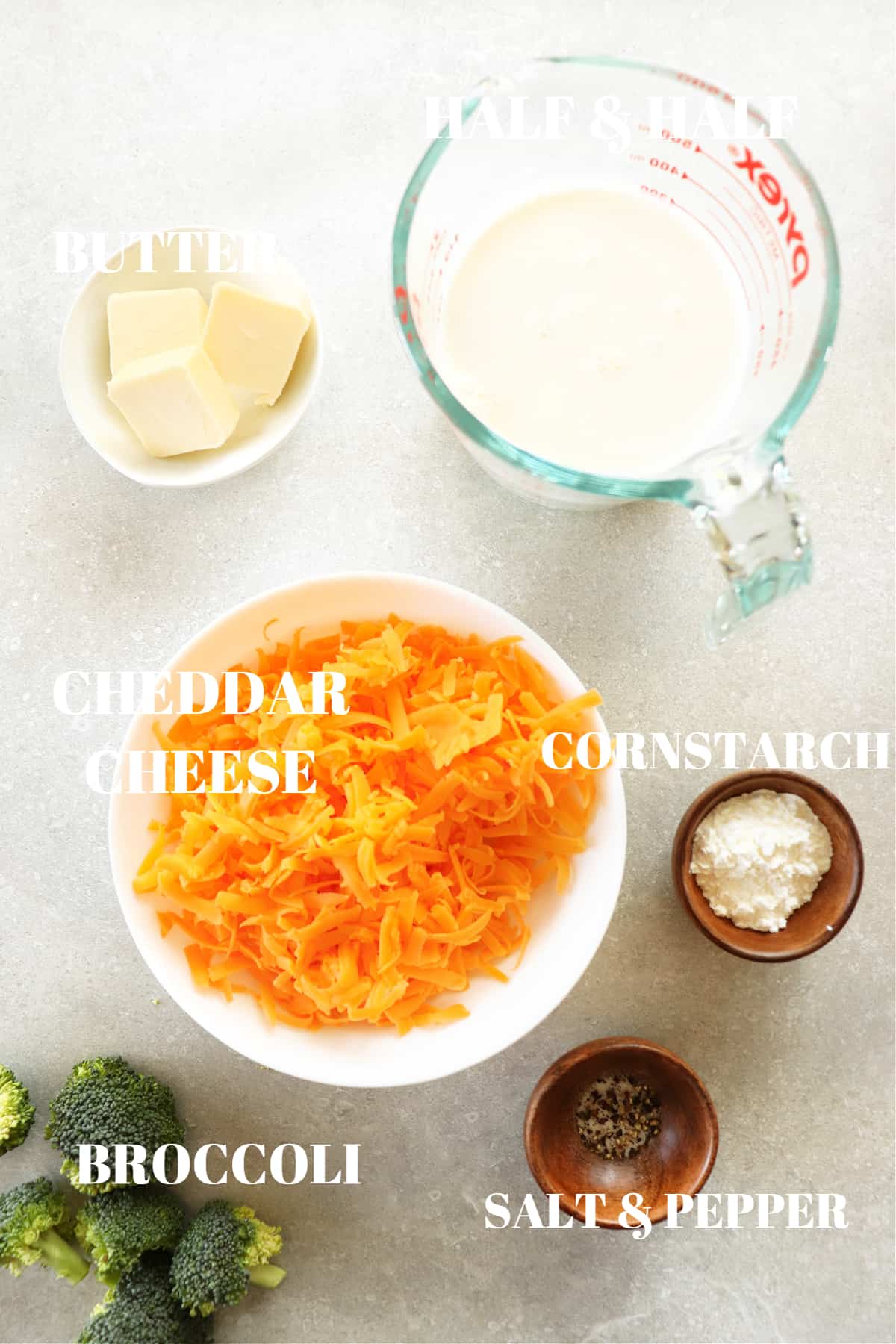 Ingredients for cheese sauce on a photography board.