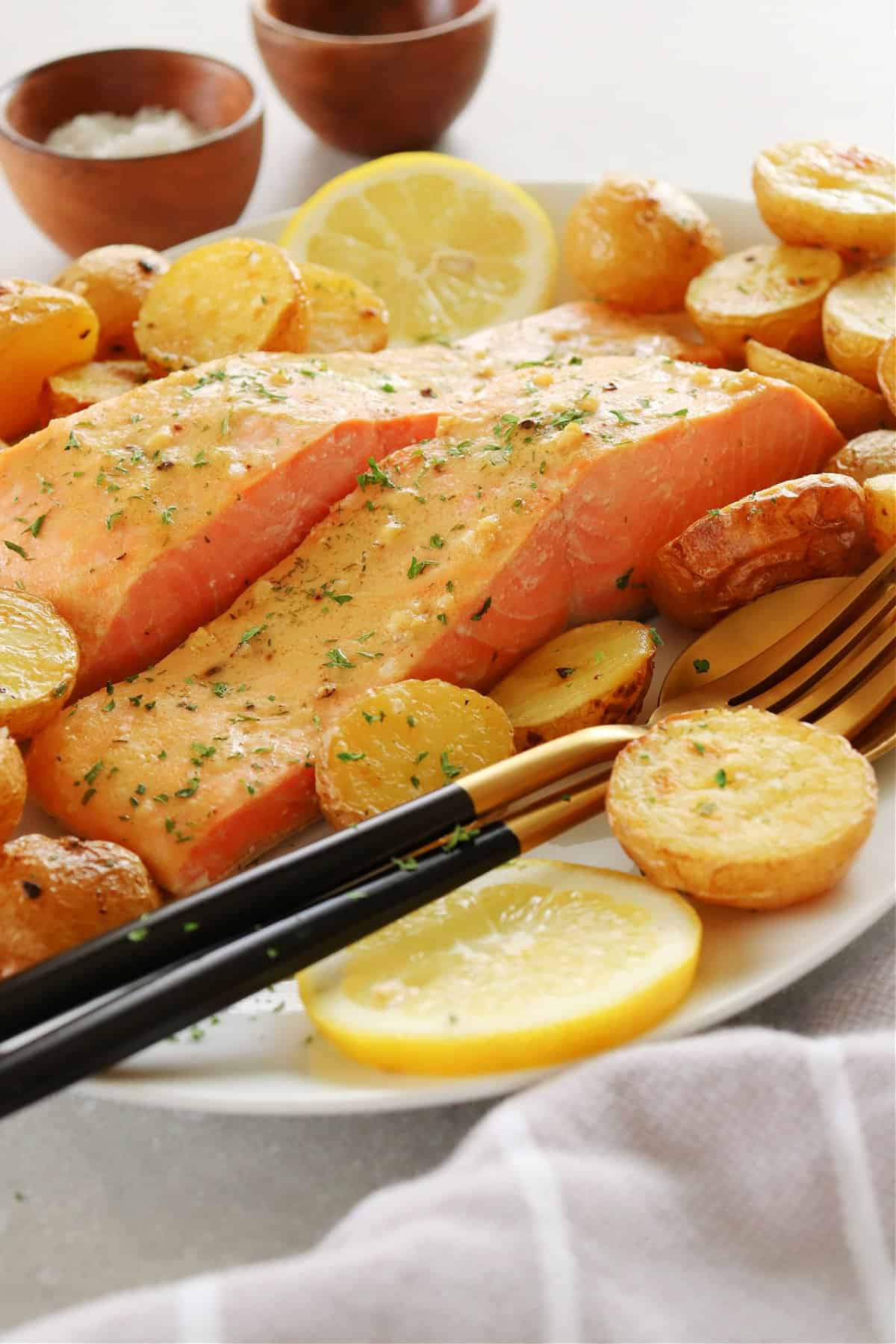 Salmon and potatoes on a serving platter with fork.