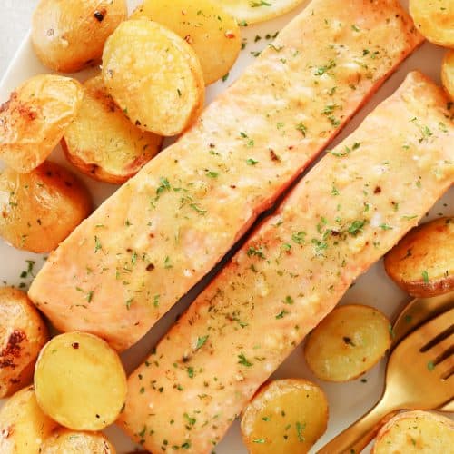 Salmon and golden potatoes on a plate.