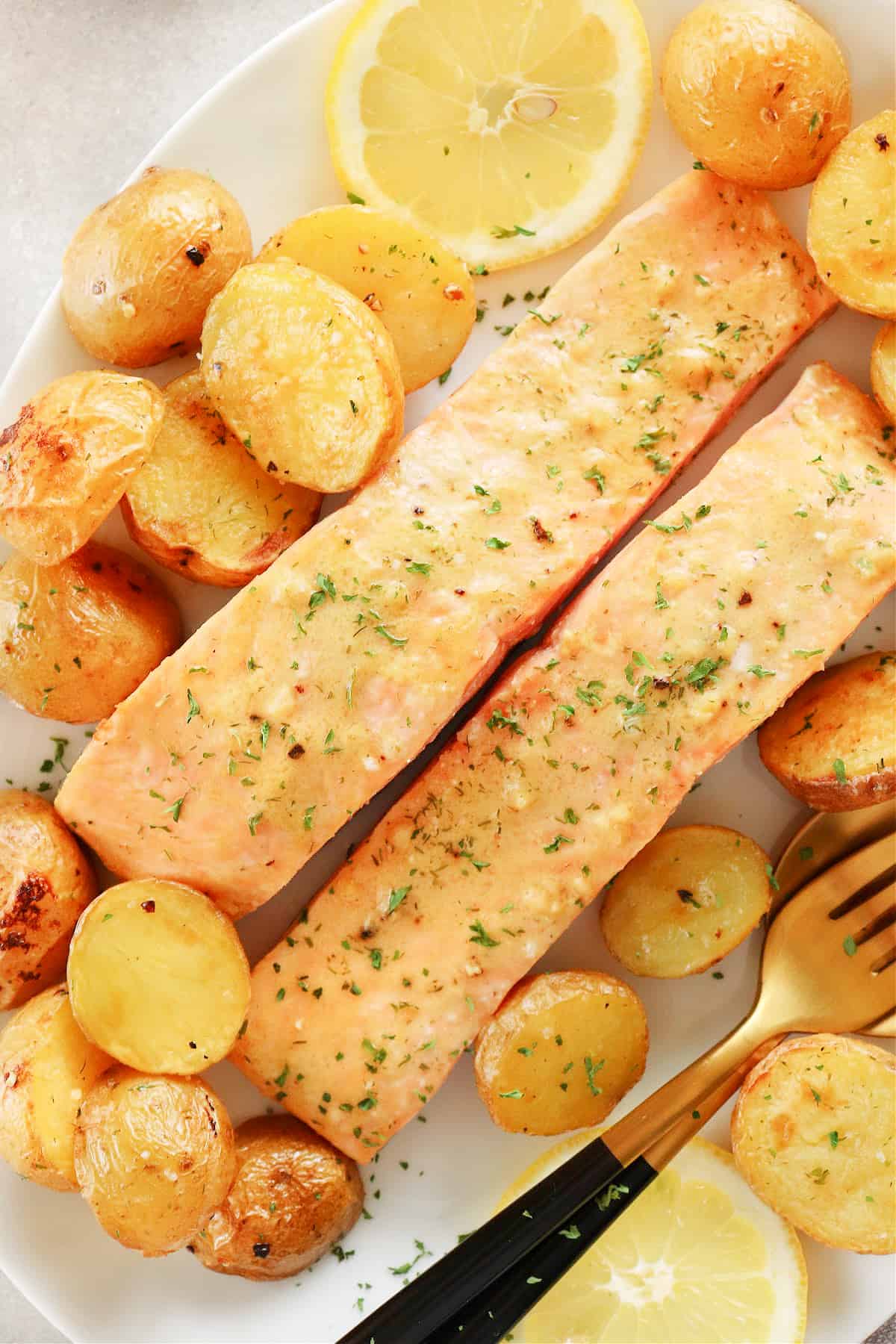 Salmon and golden potatoes on a plate.