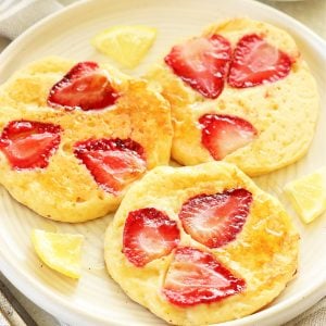 Close up of strawberry pancakes on a plate.