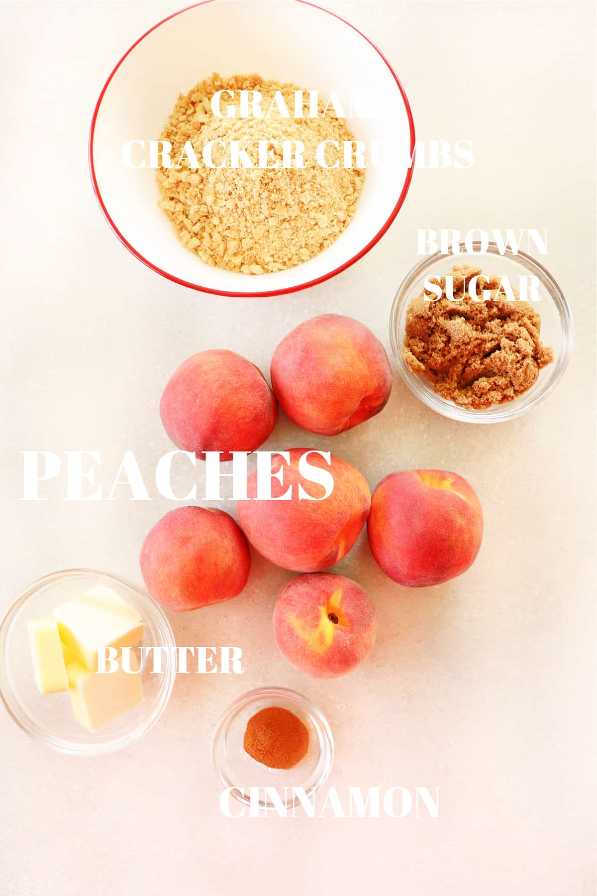 Ingredients for the air fryer peaches recipe on a gray board.