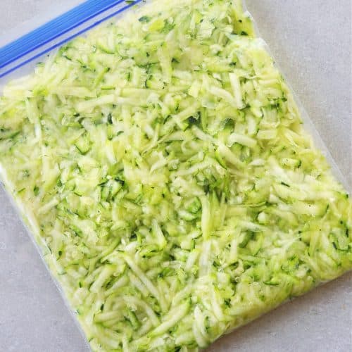 Shredded zucchini in a freezer bag.