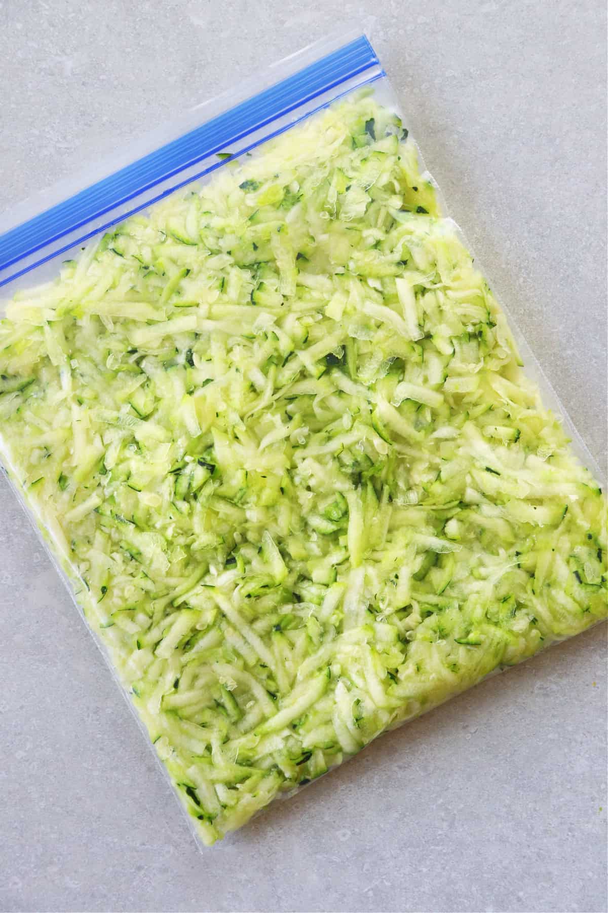 How to freeze zucchini. Shredded zucchini in a freezer bag.
