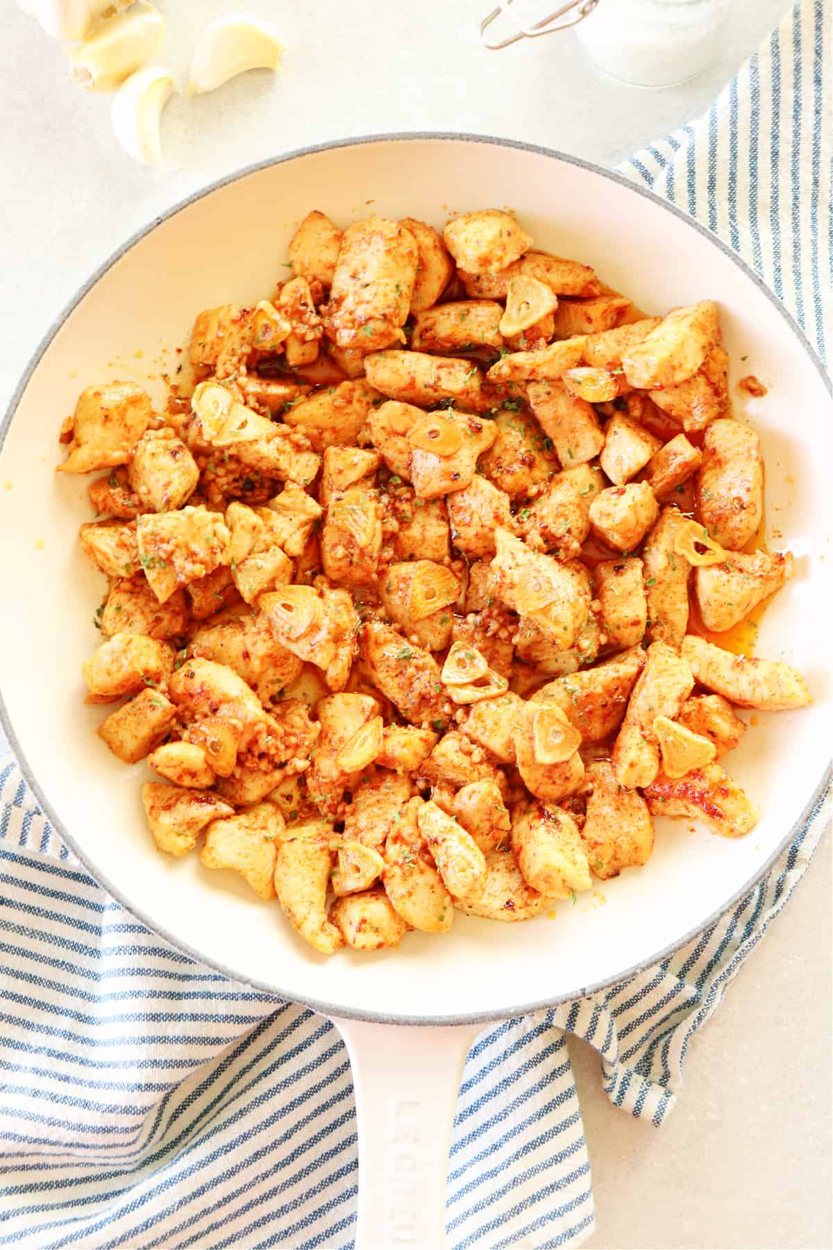 Garlic butter chicken bites in a white pan.