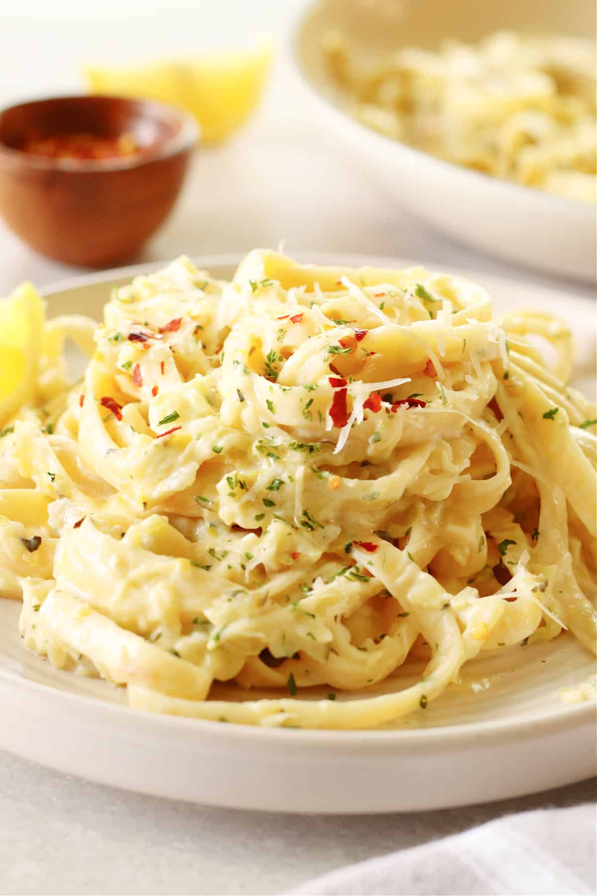 A serving of fettuccine with zucchini sauce on a cream plate.