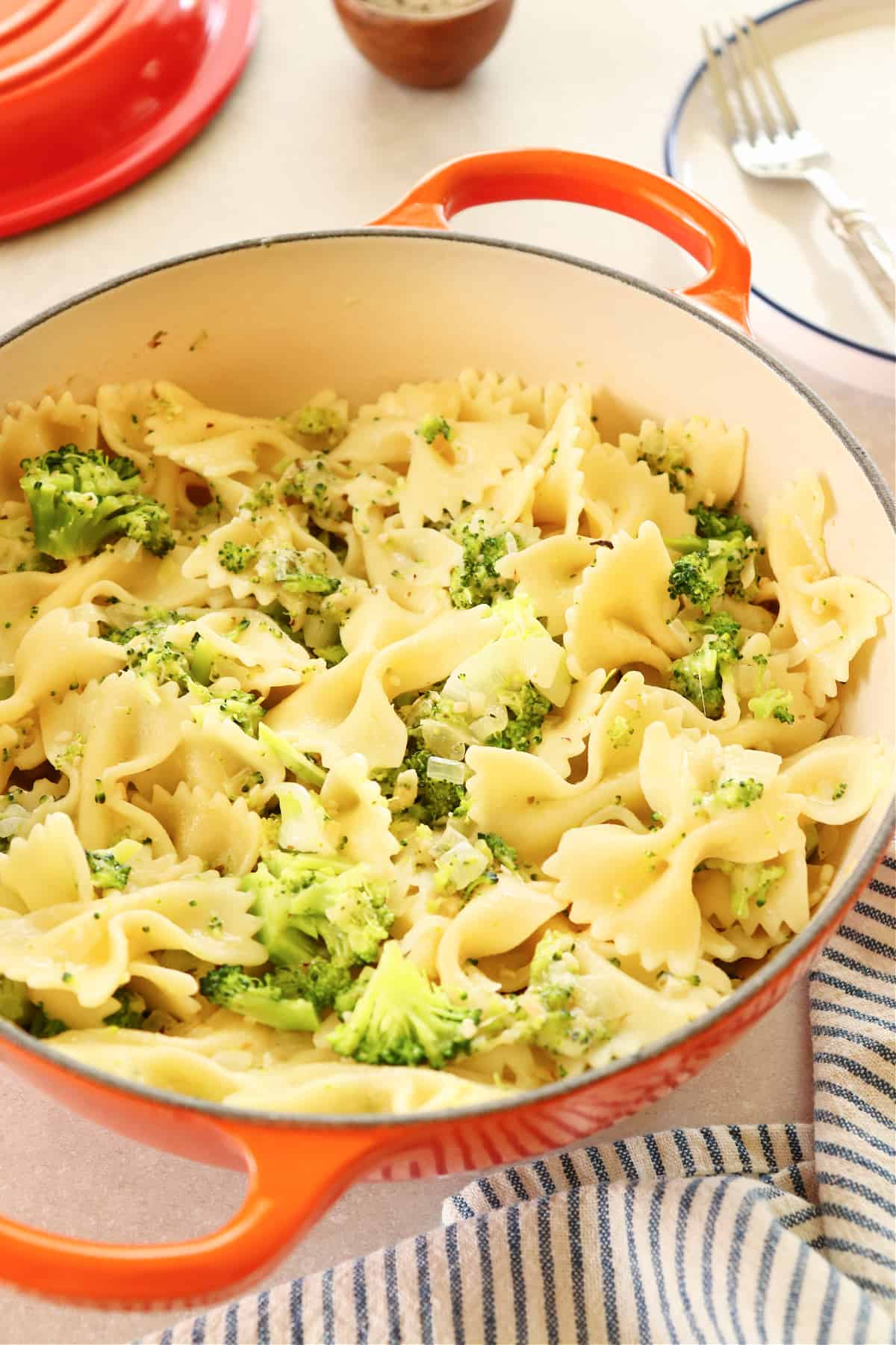 Broccoli pasta in a Le Creuset pan.
