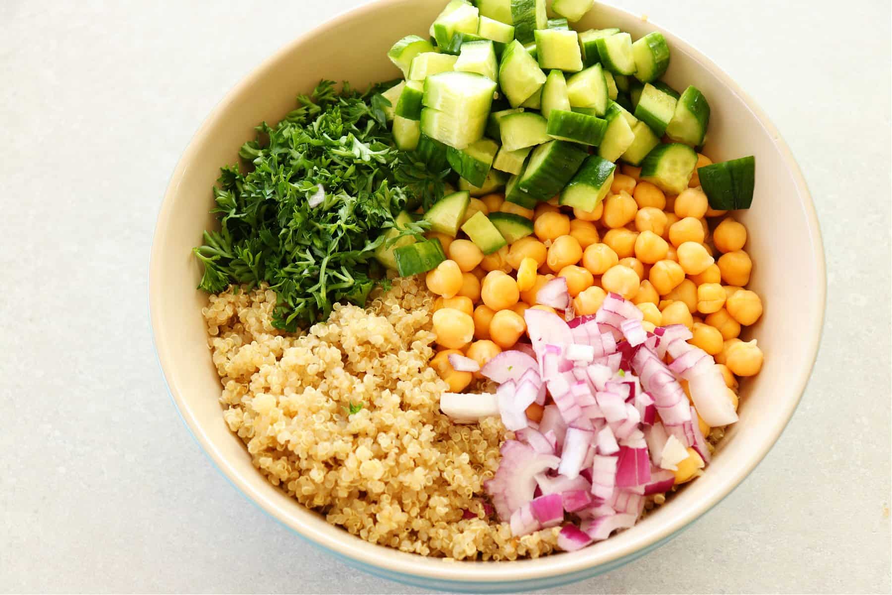 Ingredients for chickpea quinoa salad in a bowl.