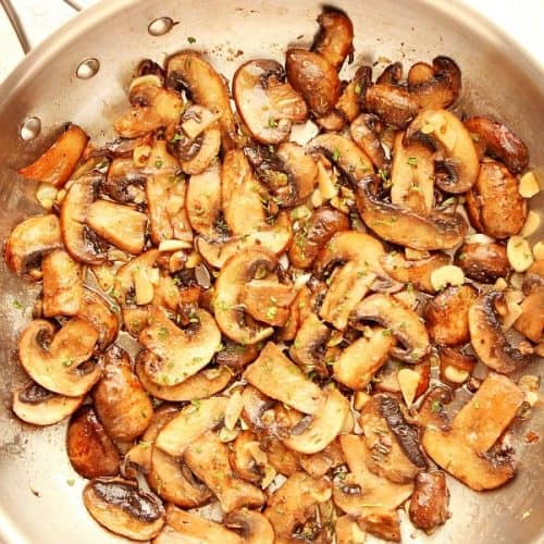 Sauteed mushrooms in a stainless steel skillet.