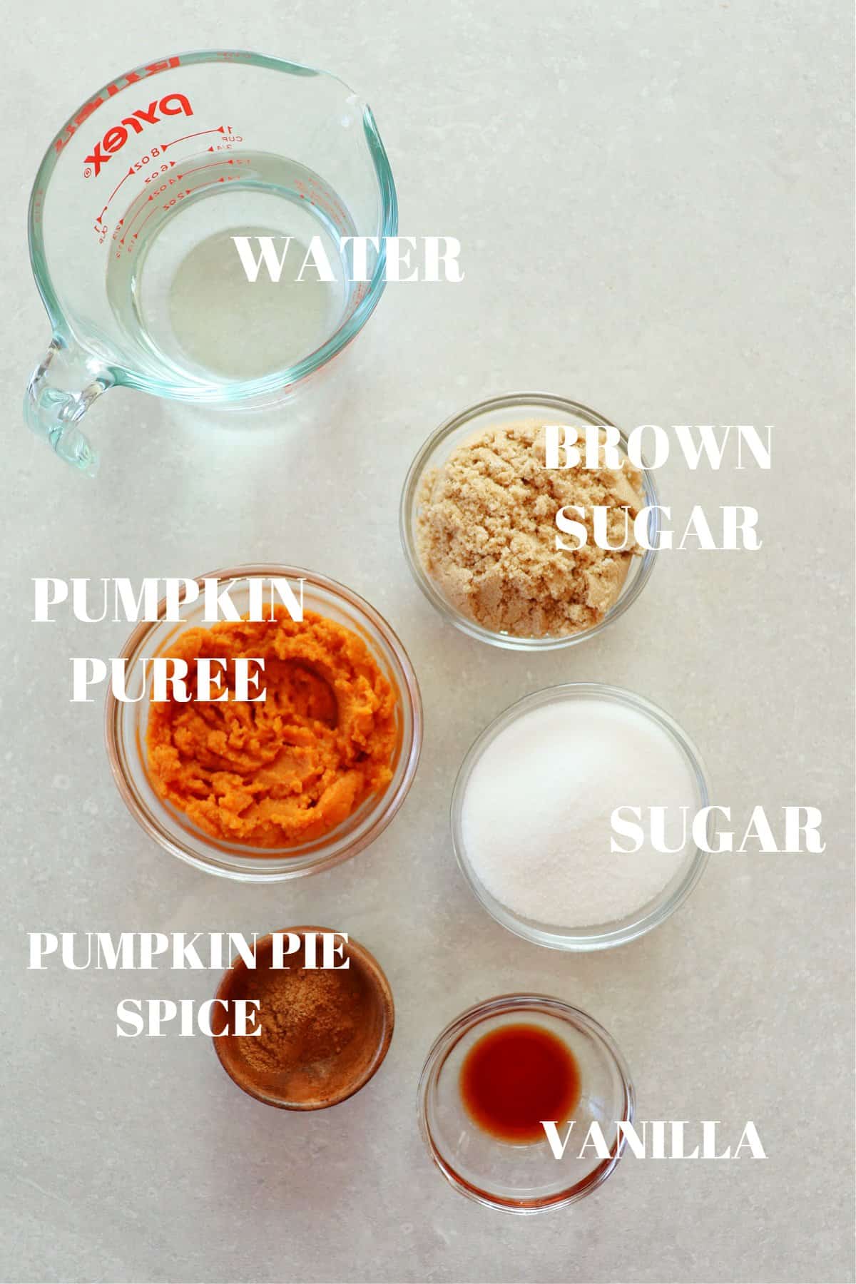 Ingredients for pumpkin syrup set on a gray background.