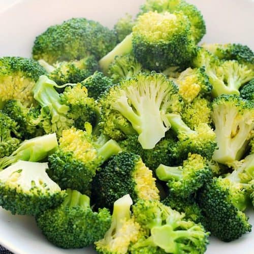 Square photo of steamed broccoli in a bowl.