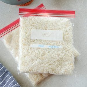 Square image of cooked rice in freezer bags.