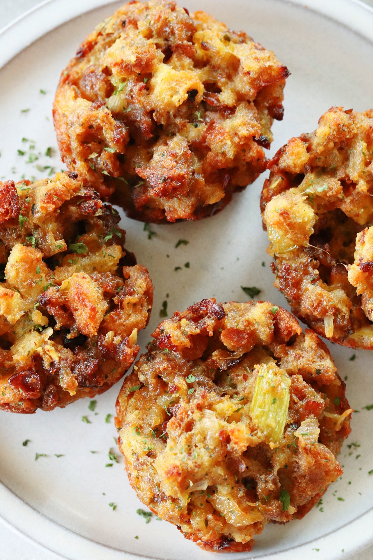 Close up photo of stuffing muffins on a gray plate.