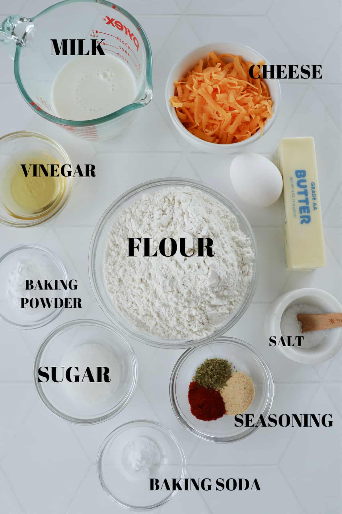 Ingredients for biscuits on a white tile board.