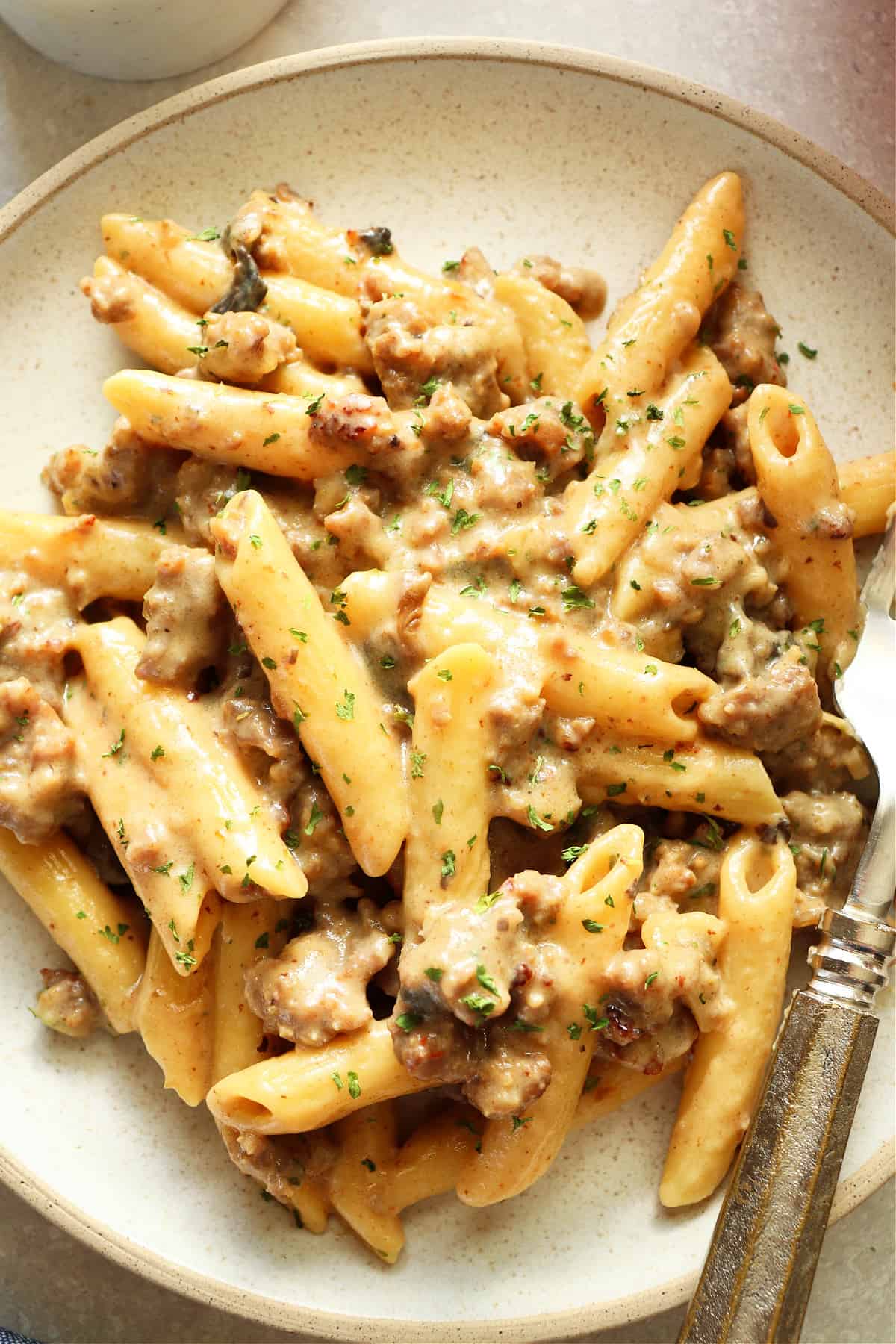 Pasta with Italian ground sausage on a plate.