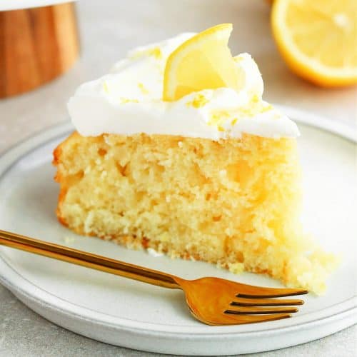 Square photo of a slice of lemon cake on a dessert plate with fork.