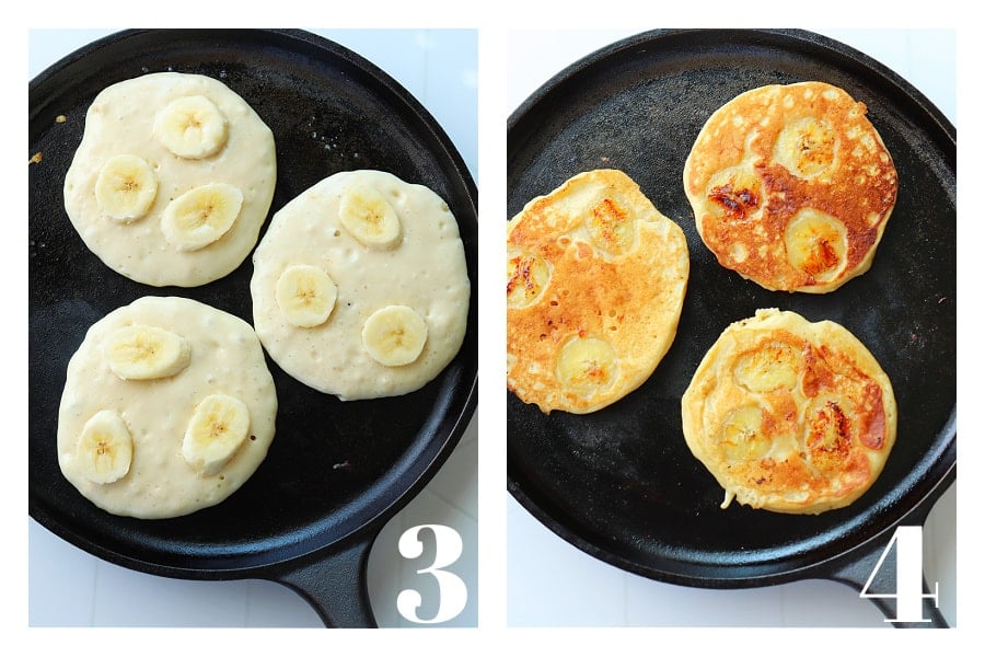 Raw side of pancakes with bananas on a cast iron griddle pan and cooked pancakes on the pan.
