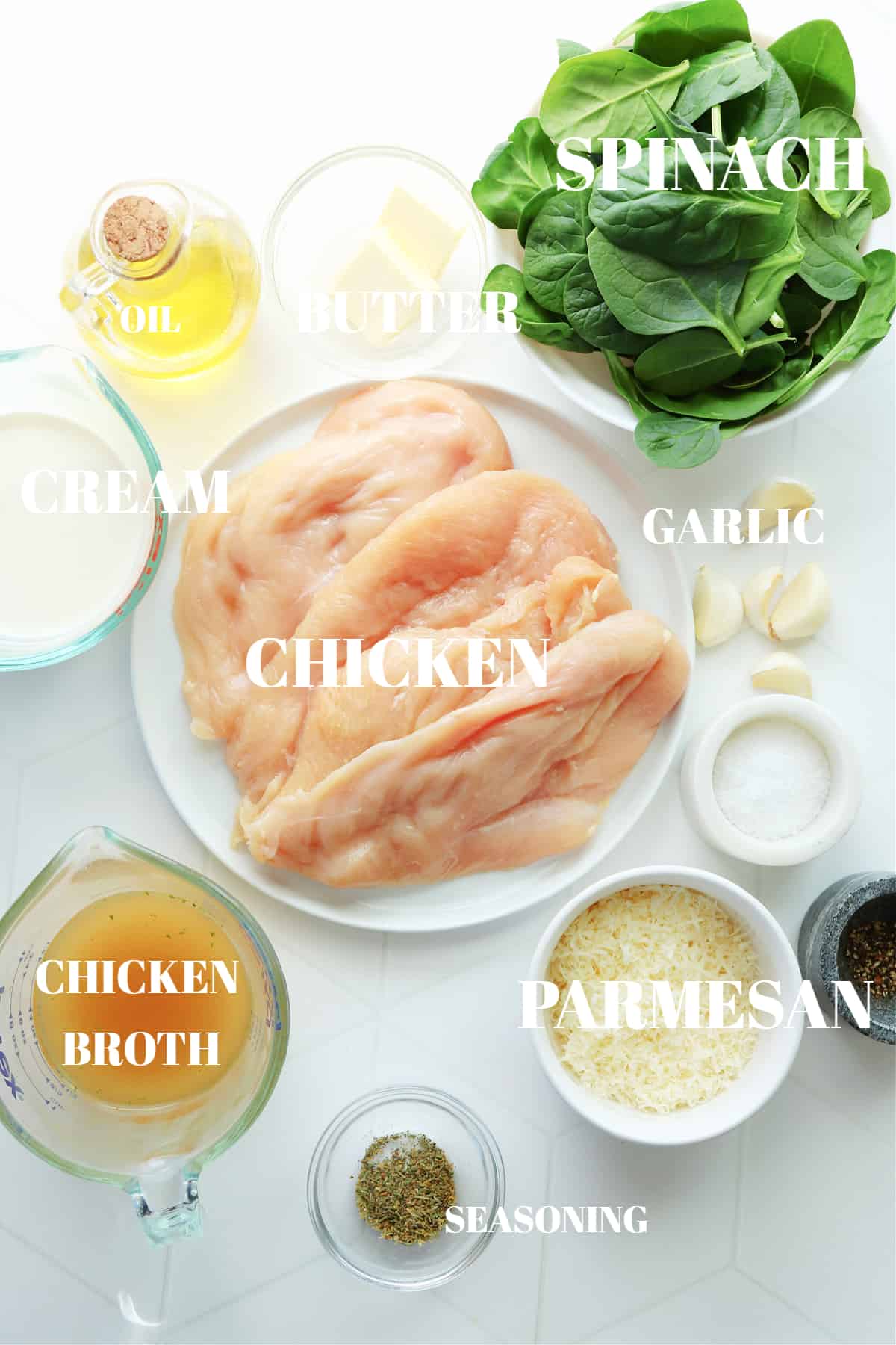 All ingredients for chicken Florentine dish on a white tile board.