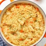 Creamy chicken and rice in an orange pan.