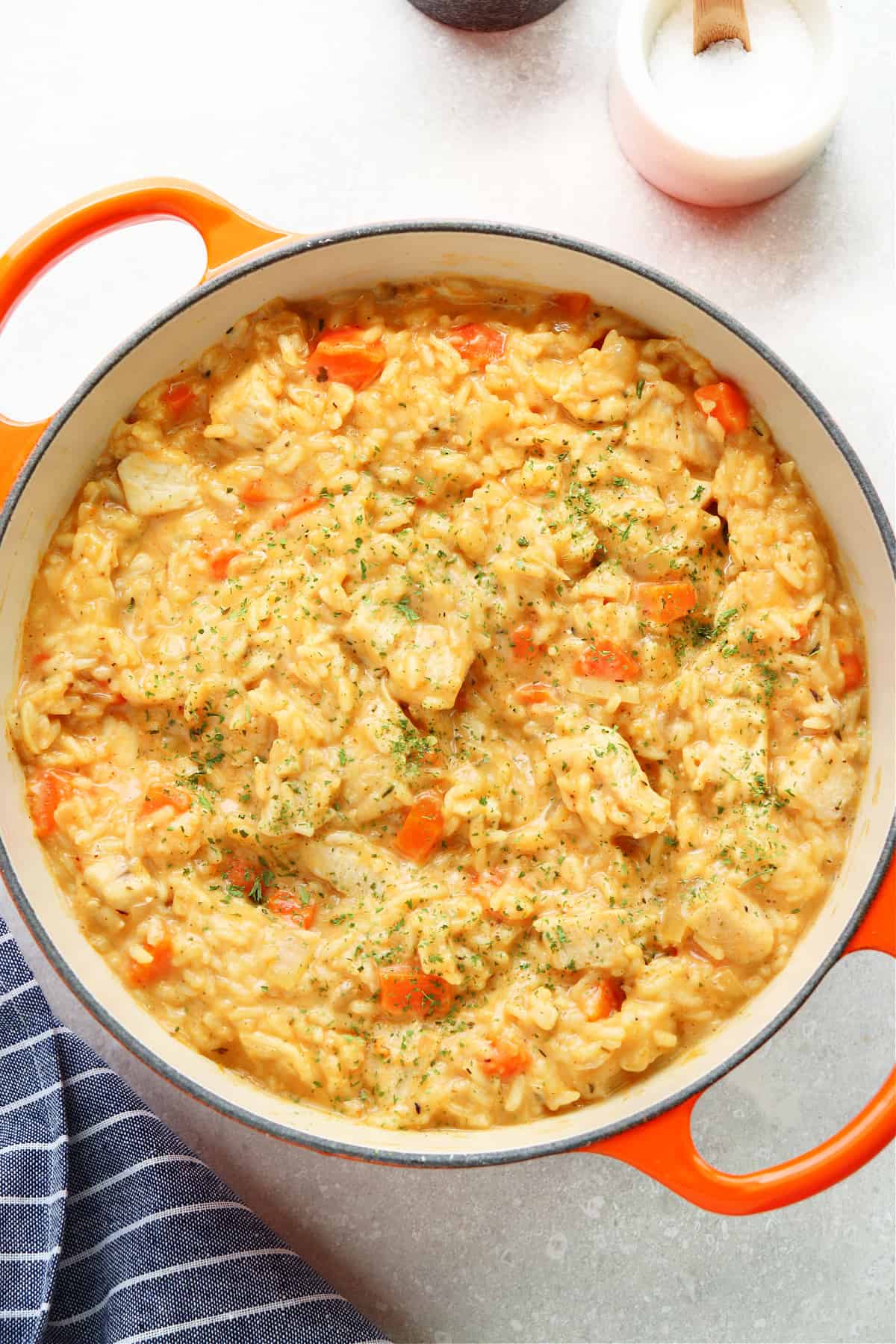 Creamy chicken and rice in an orange pan.