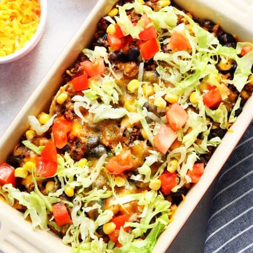 Square image of taco casserole in a baking dish.