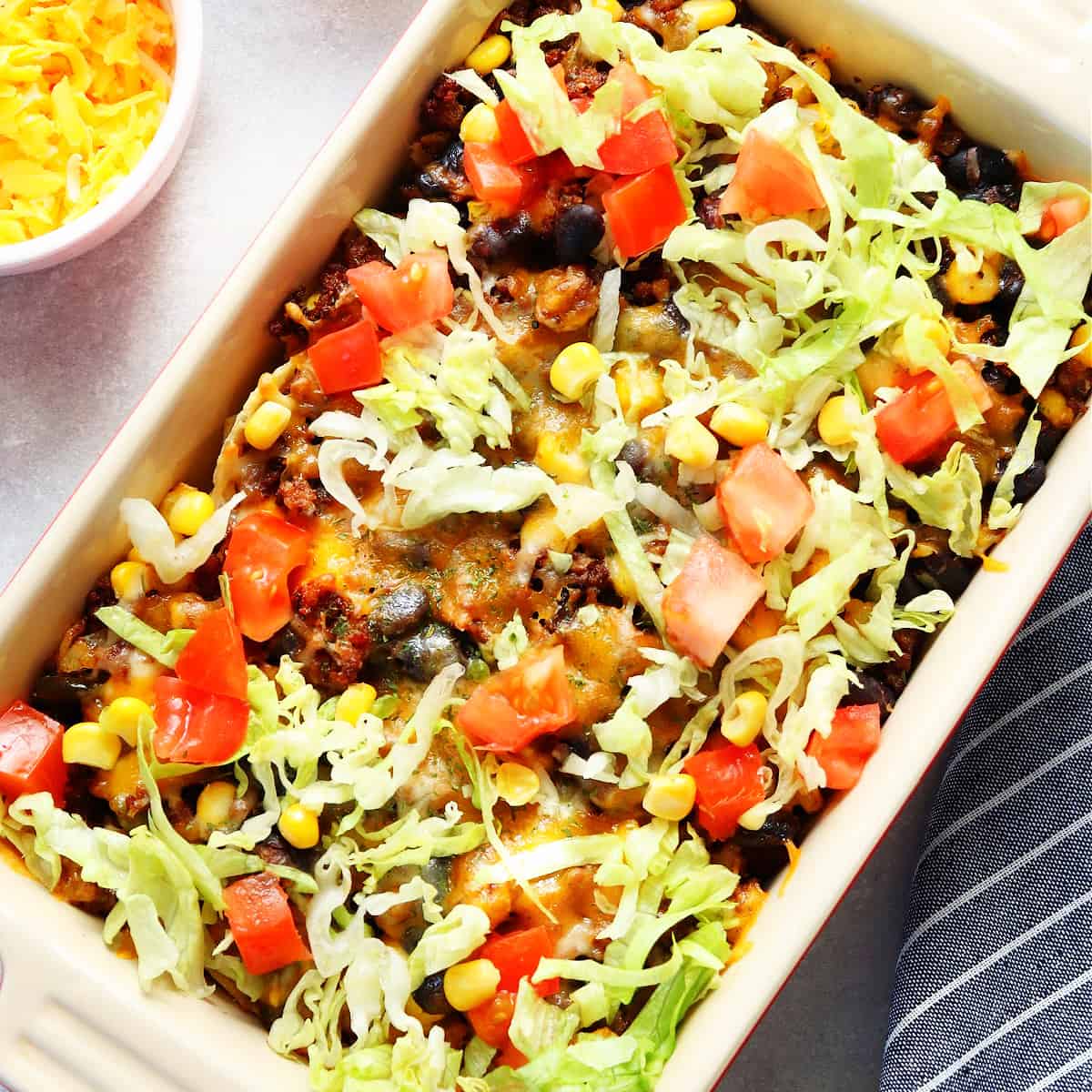 Square image of taco casserole in a baking dish.