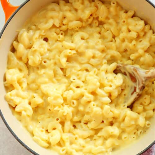 Square image of macaroni and cheese in a cooking pot.