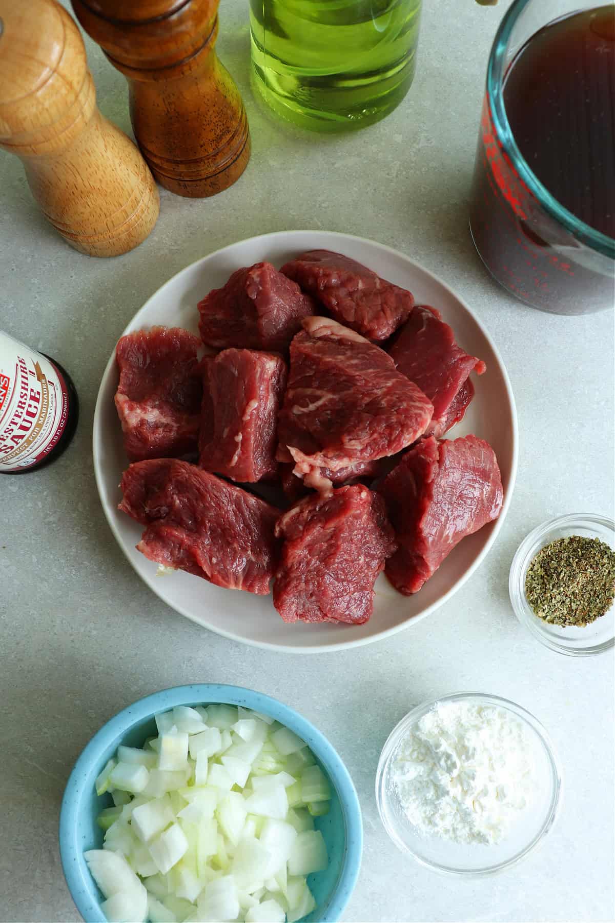 Photo of ingredients for the beef tips recipe: beef chunks, chopped onion, cornstarch and seasoning.
