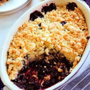 Featured image of blueberry crumble in a baking dish.
